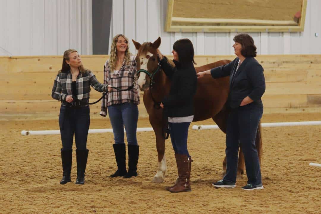 Participants stand next to adaptive riding horse Lil Rusty during a Main Stay leadership workshop.
