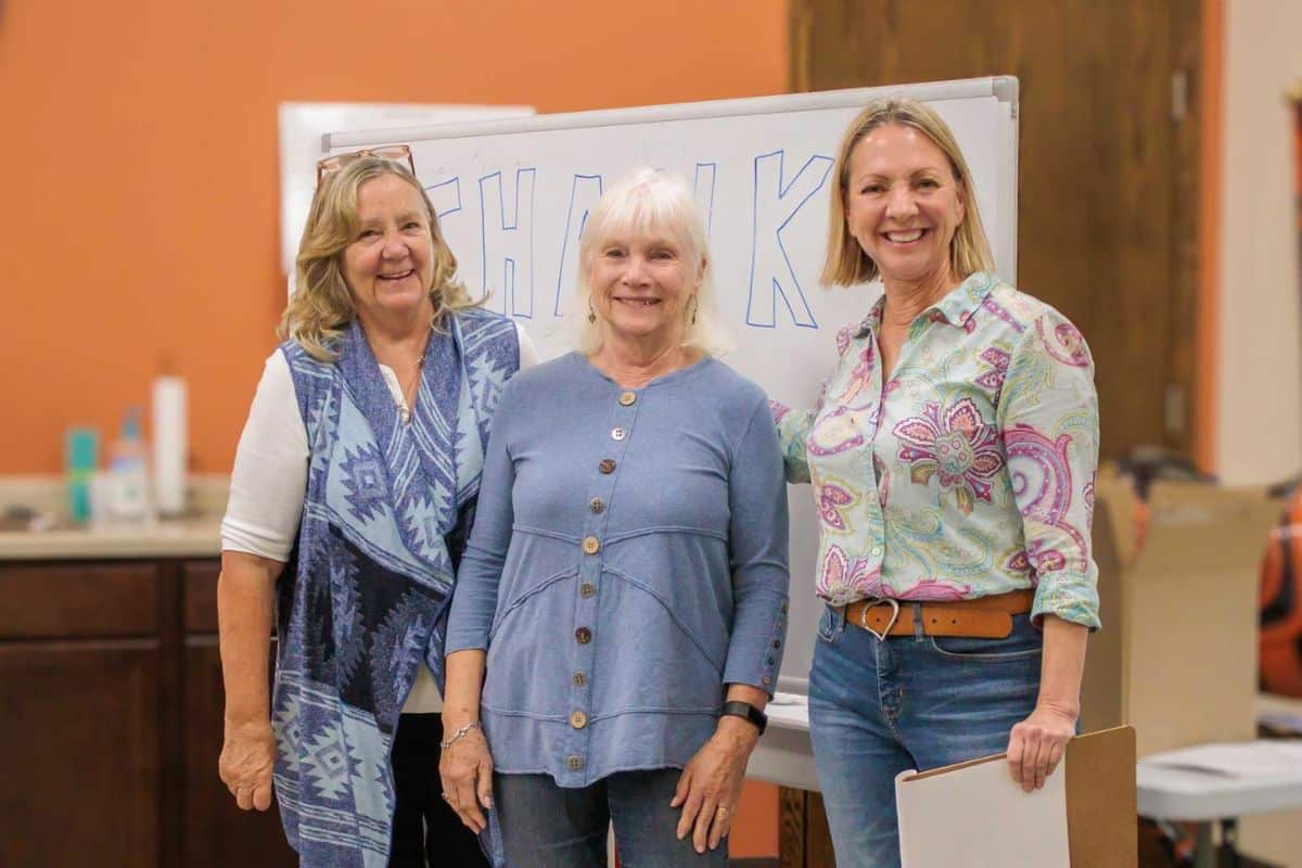 2026 Founders’ Award recipient Patty Johnson (center) with Main Stay founder Sara Foszcz (left) and Volunteer Manager Monica